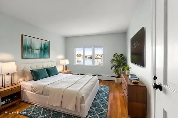 a bedroom with a bed and a flat screen tv