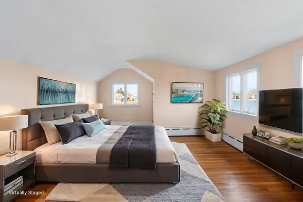 a bedroom with a bed and a flat screen tv