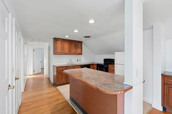 a kitchen with granite countertop a sink and a stove top oven