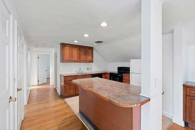 a kitchen with granite countertop a sink and a stove top oven