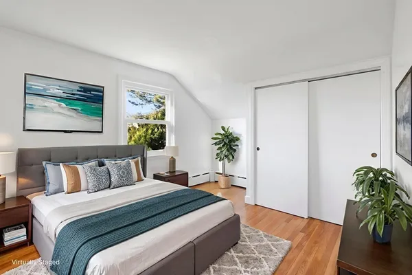 a bedroom with furniture and a potted plant