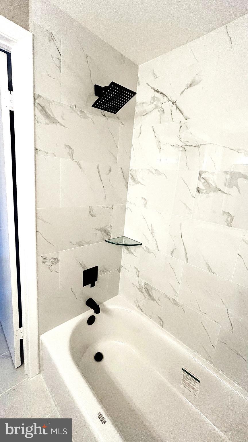 13 Consett Place, Unit 4H Frederick, MD 21703 - Photo 11 of 21 a bathroom with a bathtub and shower