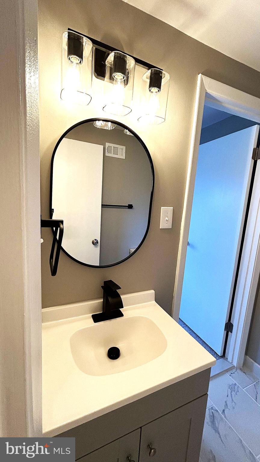 13 Consett Place, Unit 4H Frederick, MD 21703 - Photo 13 of 21 a bathroom with a sink and mirror