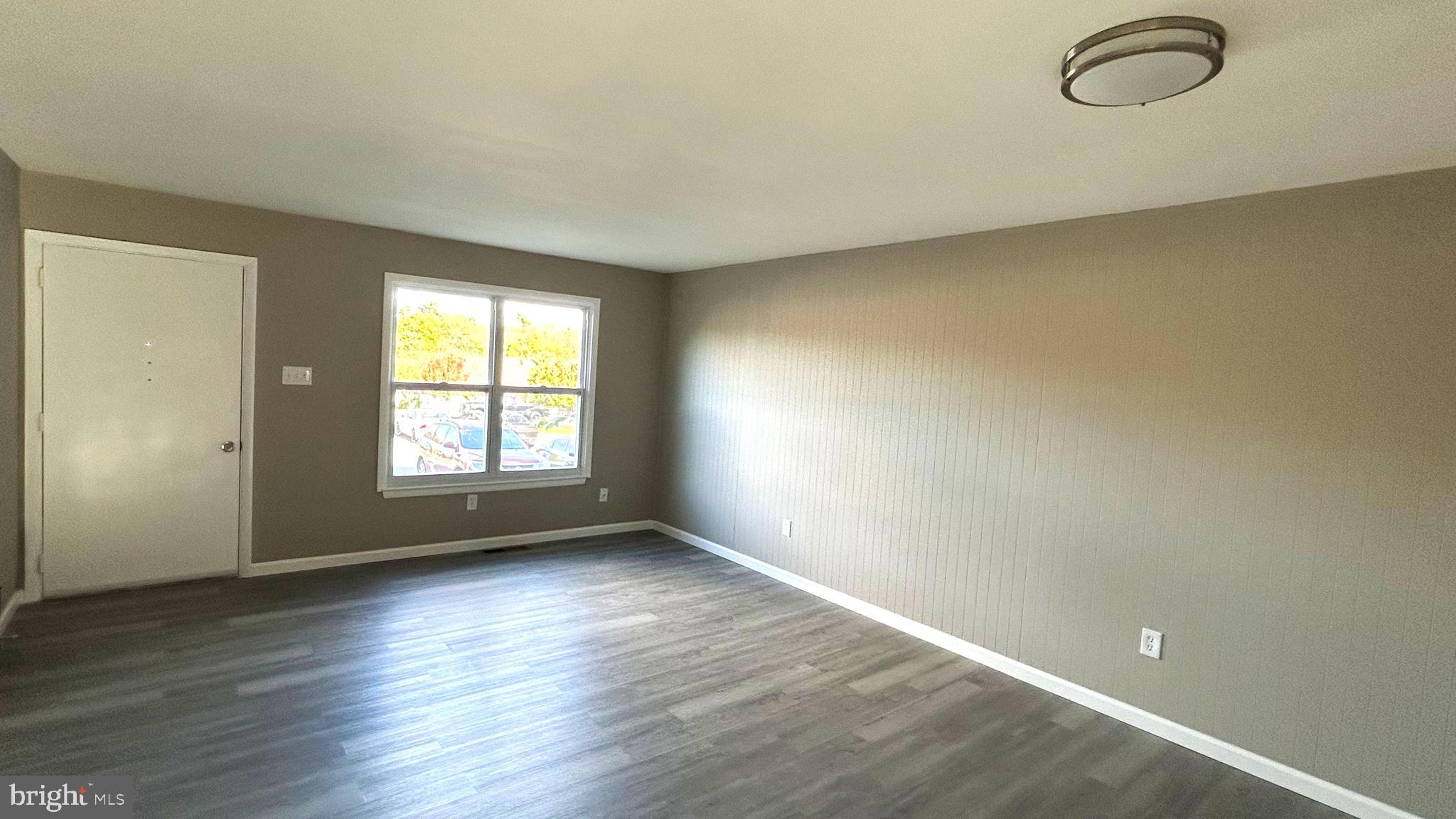 13 Consett Place, Unit 4H Frederick, MD 21703 - Photo 2 of 21 an empty room with wooden floor and windows