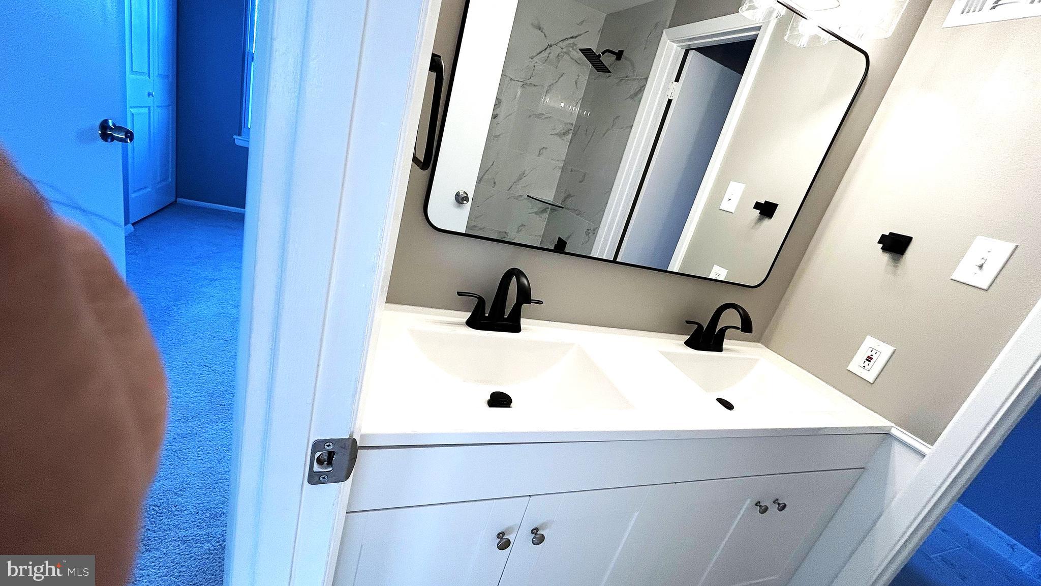 13 Consett Place, Unit 4H Frederick, MD 21703 - Photo 10 of 21 a bathroom with a sink and mirror with vanity