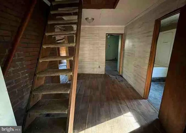 a view of a room with wooden floor
