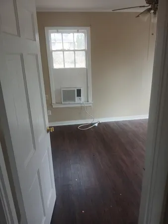 a view of room with window and hardwood floor