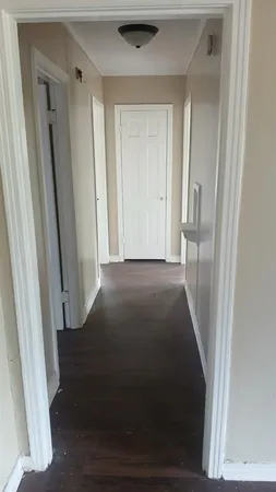 an empty room with wooden floor and a window