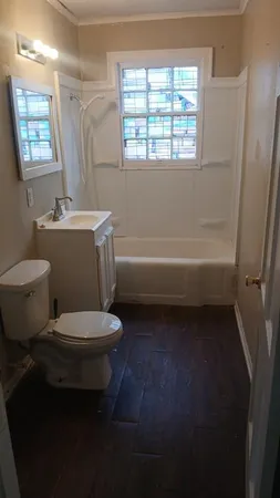 an empty room with a window and a ceiling fan