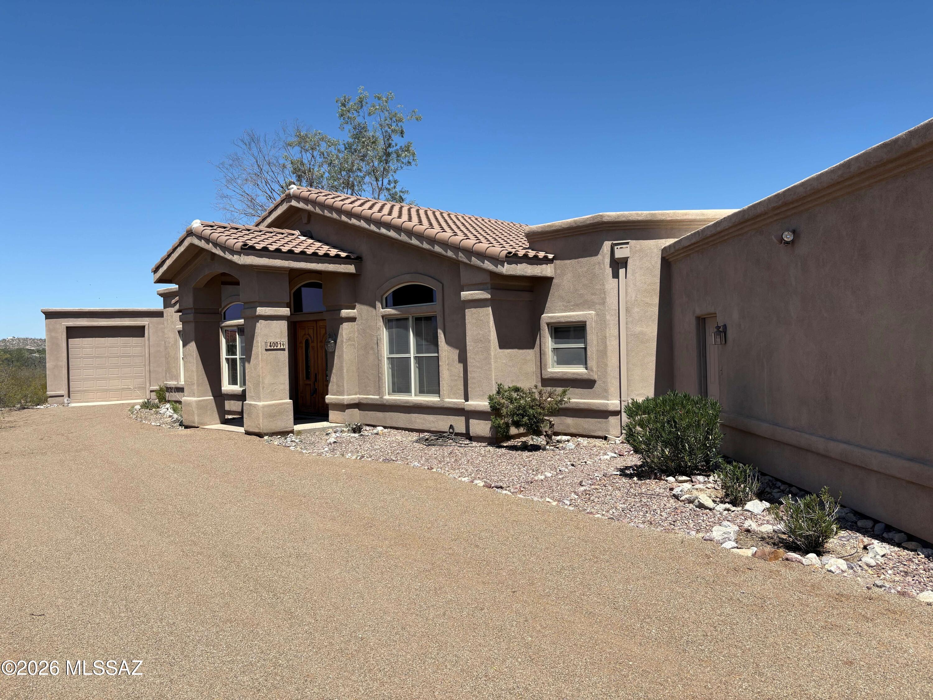 4001 North Harrison Road Tucson, AZ 85749 - Photo 2 of 50 a front view of a house with a yard