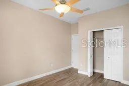 a view of an empty room with wooden floor
