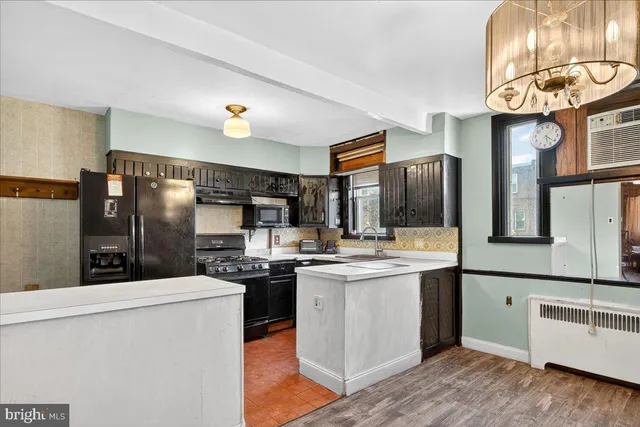 a kitchen with stainless steel appliances granite countertop a stove and a refrigerator