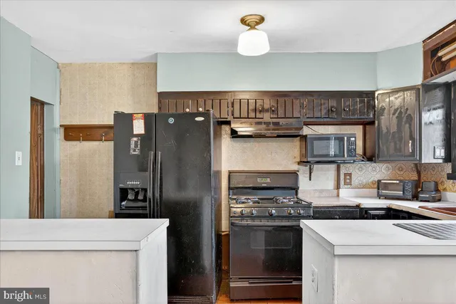 a kitchen with a sink stove and cabinets