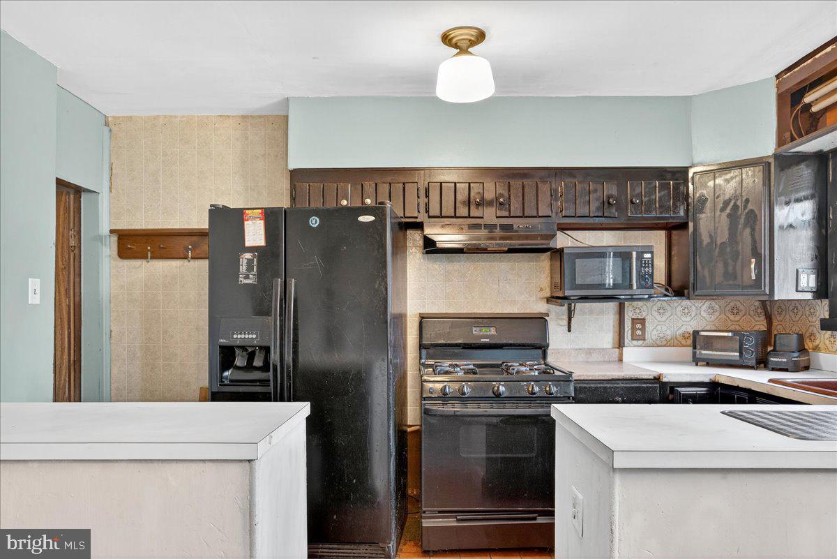 1440 Robbins Street Philadelphia, PA 19149 - Photo 13 of 31 a kitchen with stainless steel appliances granite countertop a stove and a refrigerator