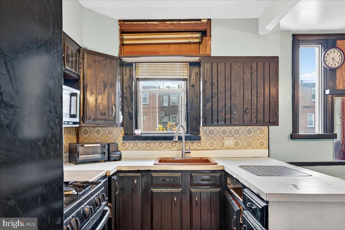 1440 Robbins Street Philadelphia, PA 19149 - Photo 15 of 31 a kitchen with a sink stove and cabinets