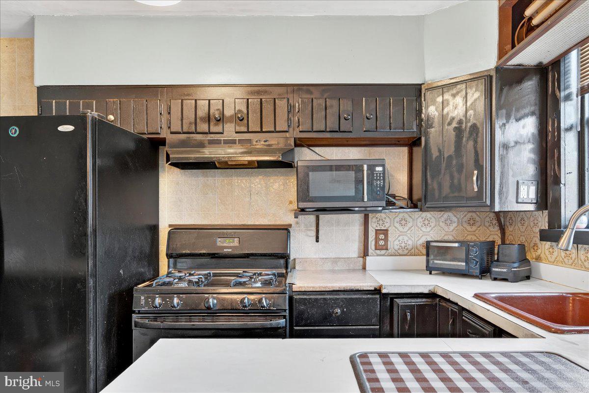 1440 Robbins Street Philadelphia, PA 19149 - Photo 16 of 31 a kitchen with stainless steel appliances granite countertop a stove and a sink