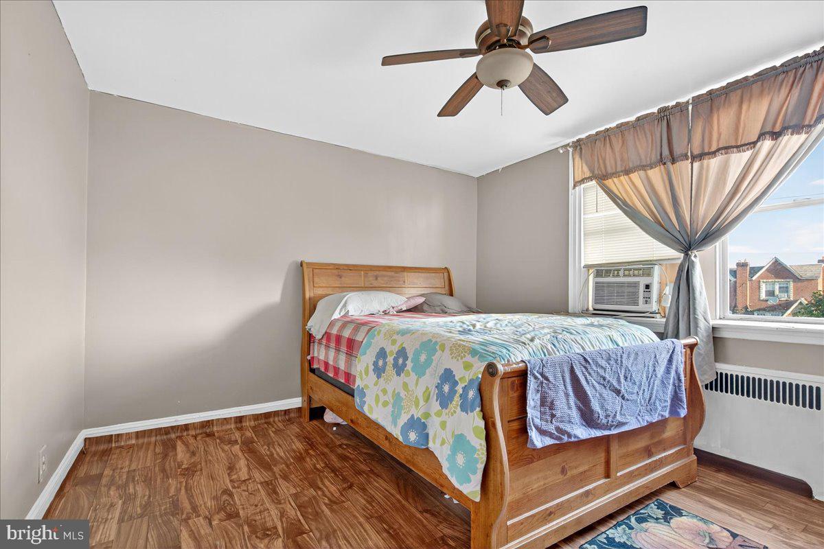 1440 Robbins Street Philadelphia, PA 19149 - Photo 17 of 31 a bedroom with a bed a chandelier and next to a window