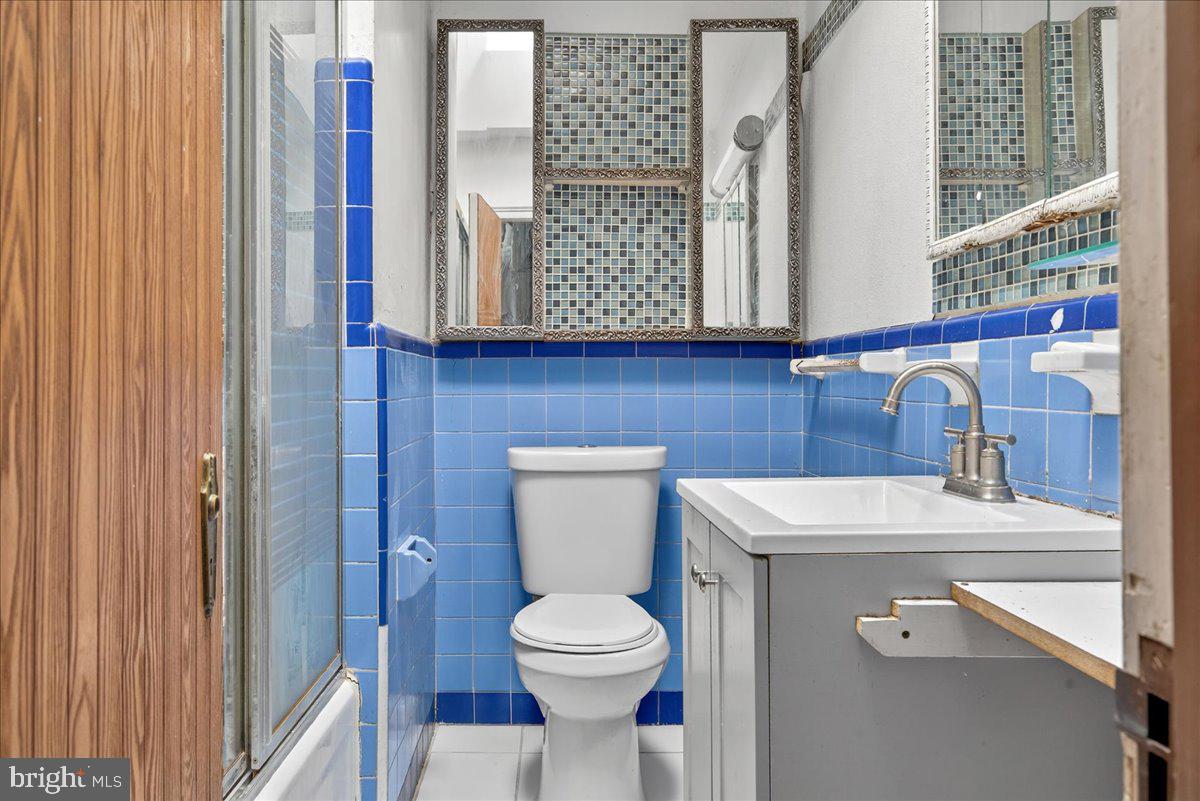 1440 Robbins Street Philadelphia, PA 19149 - Photo 19 of 31 a bathroom with a toilet a sink and mirror