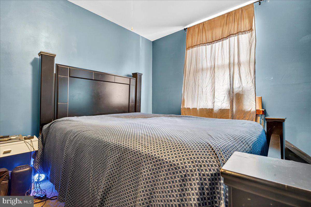 1440 Robbins Street Philadelphia, PA 19149 - Photo 21 of 31 a bedroom with a bed and wooden floor
