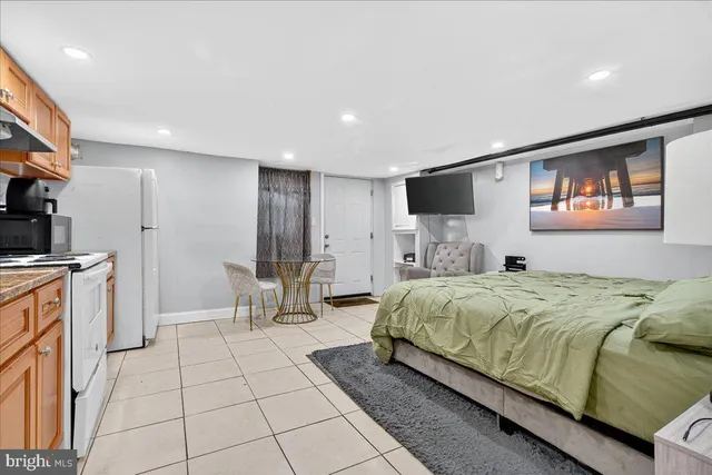 a kitchen with a sink a stove top oven and cabinets