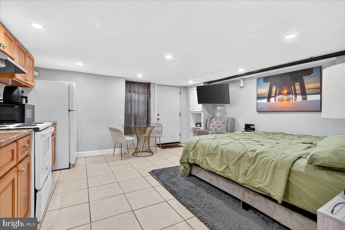 1440 Robbins Street Philadelphia, PA 19149 - Photo 23 of 31 a bedroom with a bed and a flat screen tv