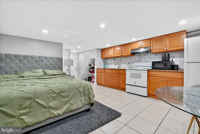 a kitchen with stainless steel appliances granite countertop a sink a refrigerator and a stove