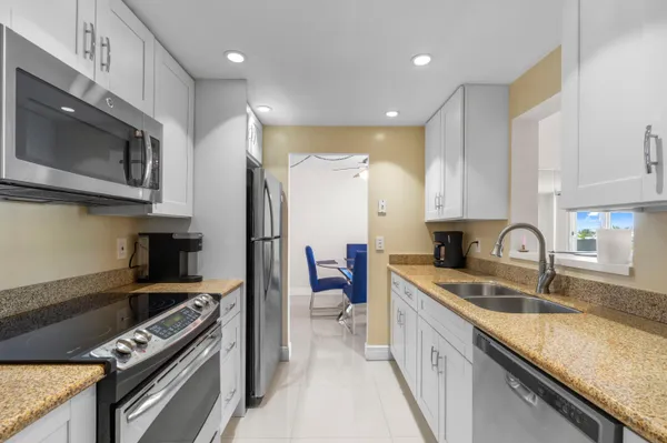 a kitchen with a sink stainless steel appliances and cabinets
