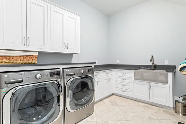 a utility room with sink dryer and washer