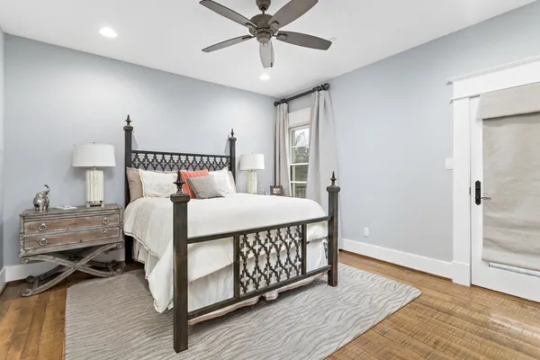 a bedroom with a bed and wooden floor