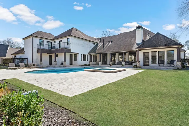 a view of a patio with table and chairs