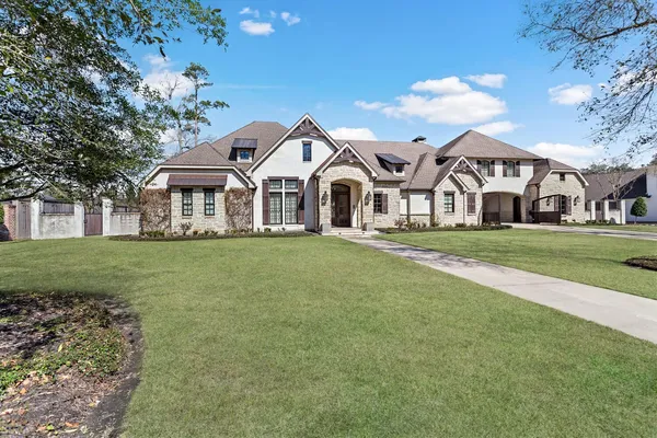 a front view of a house with a garden