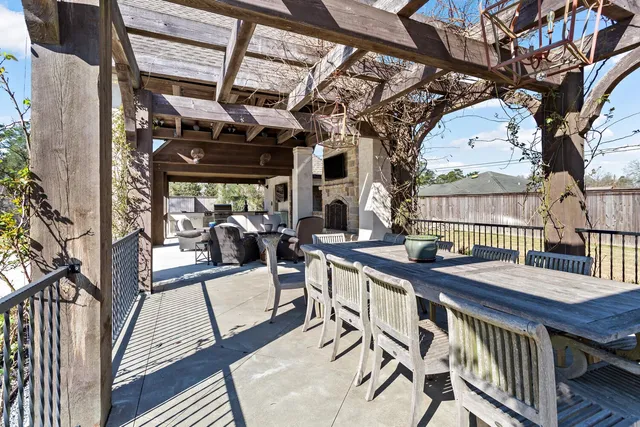 a living room with stainless steel appliances furniture a fireplace and a flat screen tv