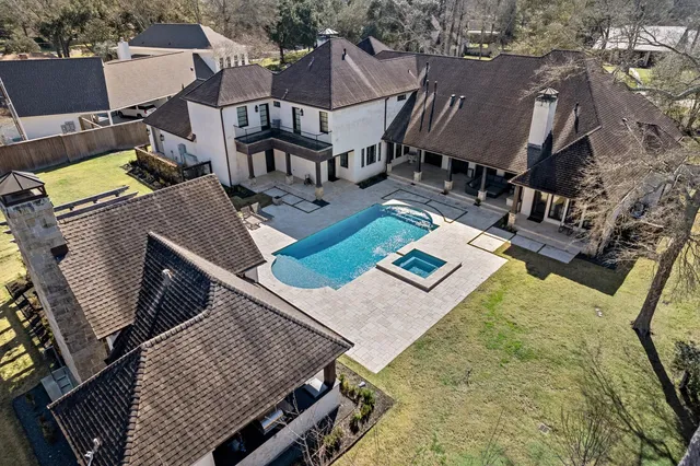 an aerial view of a house with pool and patio