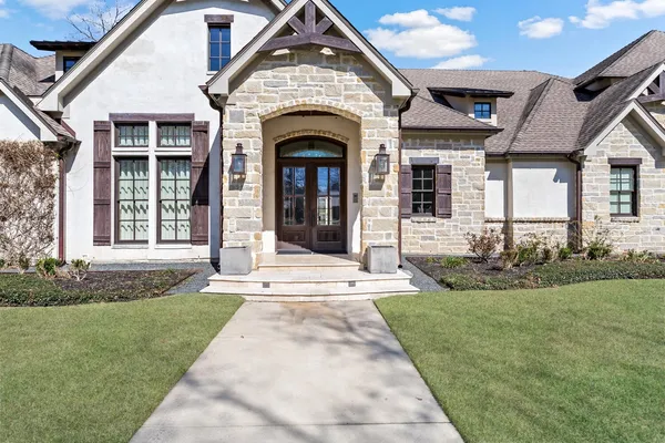 a front view of a house with a garden
