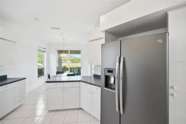 a kitchen with white cabinets and appliances