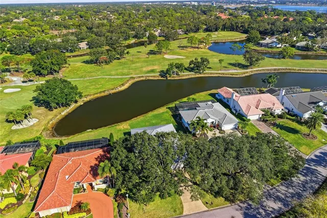 an aerial view of a house with a lake view