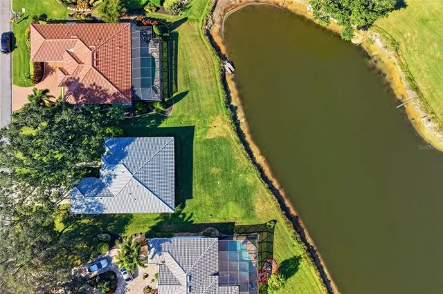 a view of house with swimming pool and outdoor seating