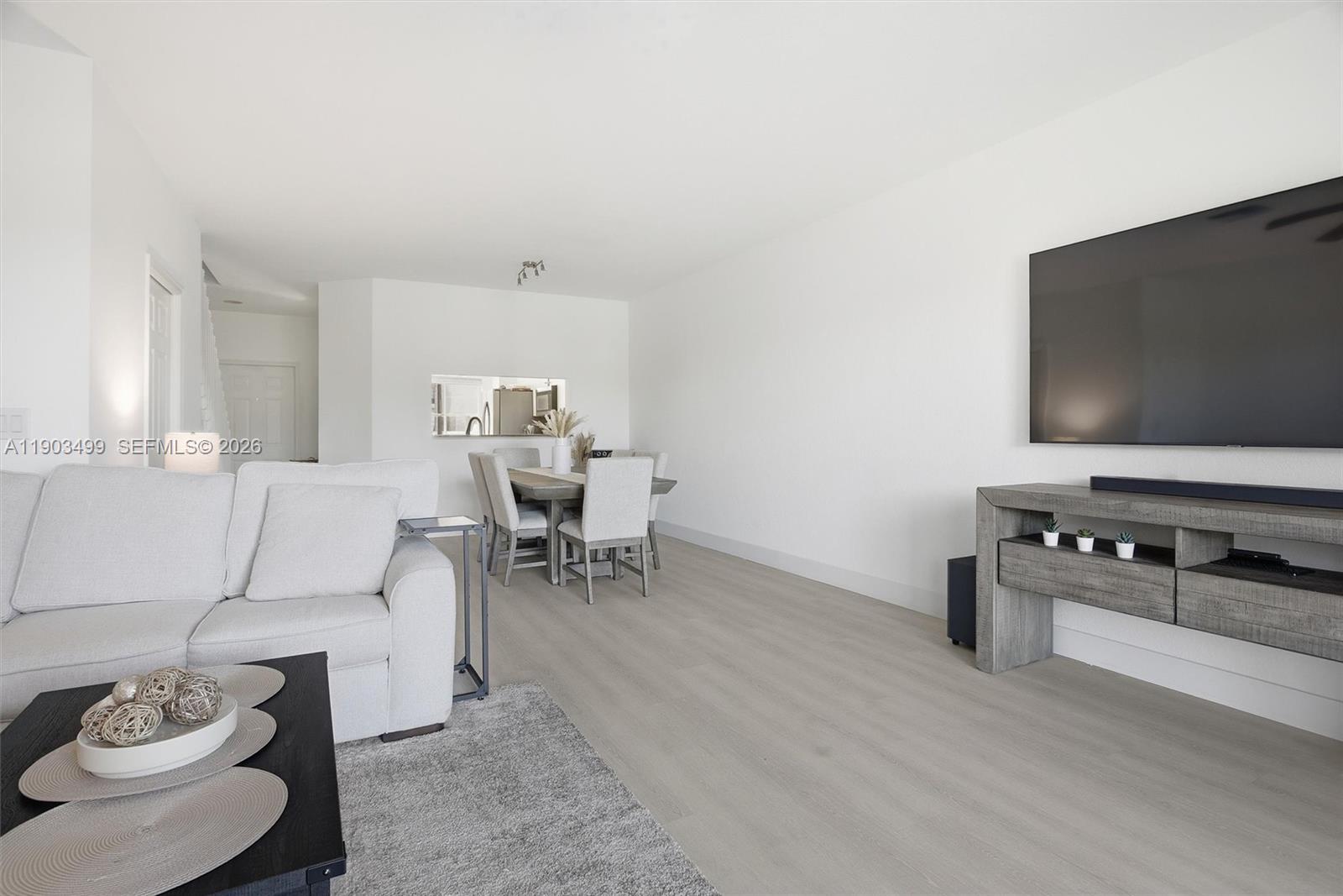 8231 Southwest 29th Street Miramar, FL 33025 - Photo 23 of 53 a living room with furniture and a flat screen tv