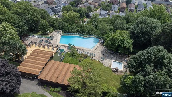 an aerial view of a house with a garden and lake view