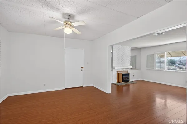 a view of a livingroom with a ceiling fan and window