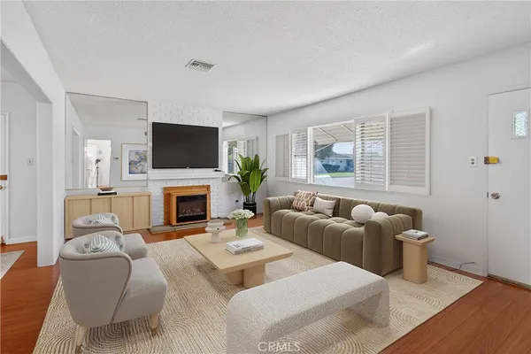 a living room with furniture a fireplace and a flat screen tv