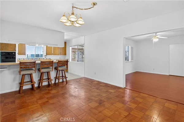 an empty room with wooden floor and window