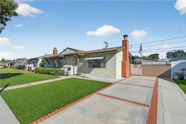 a view of a house with a backyard and porch