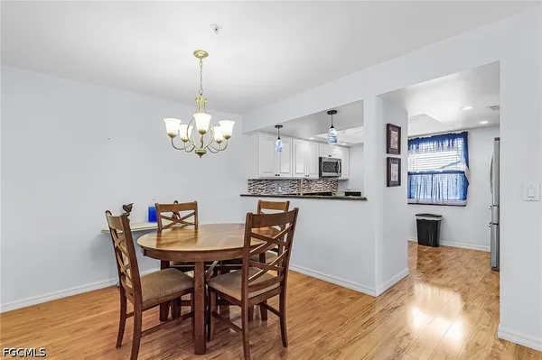 a view of a dining room with furniture and chandelier