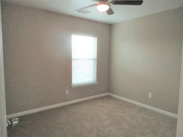 a bathroom with a granite countertop toilet sink and mirror