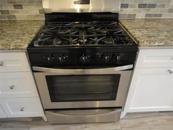 a kitchen with stainless steel appliances a refrigerator stove and microwave