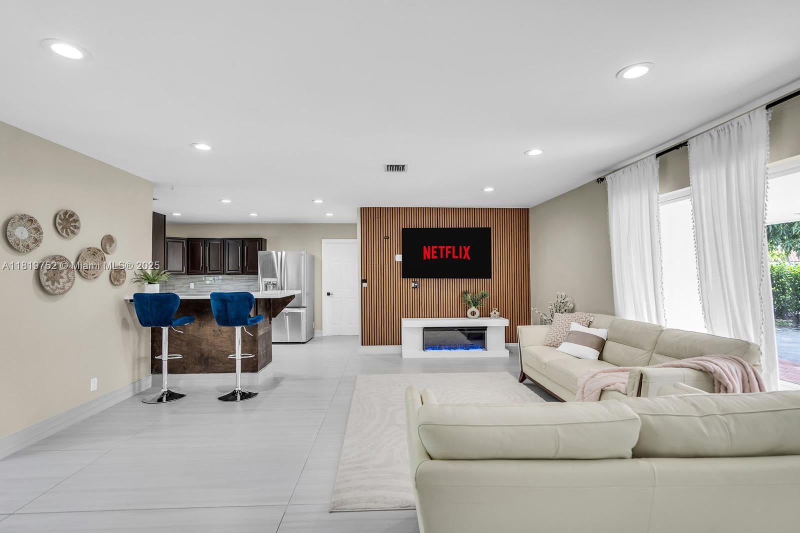 a living room with furniture and a flat screen tv