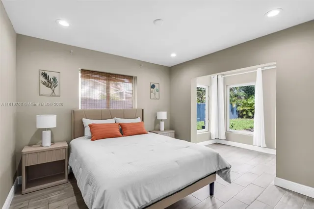 a bedroom with a large bed and a window