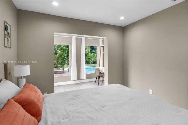 a bedroom with a large bed and a large window