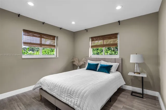 a bedroom with a bed and a window